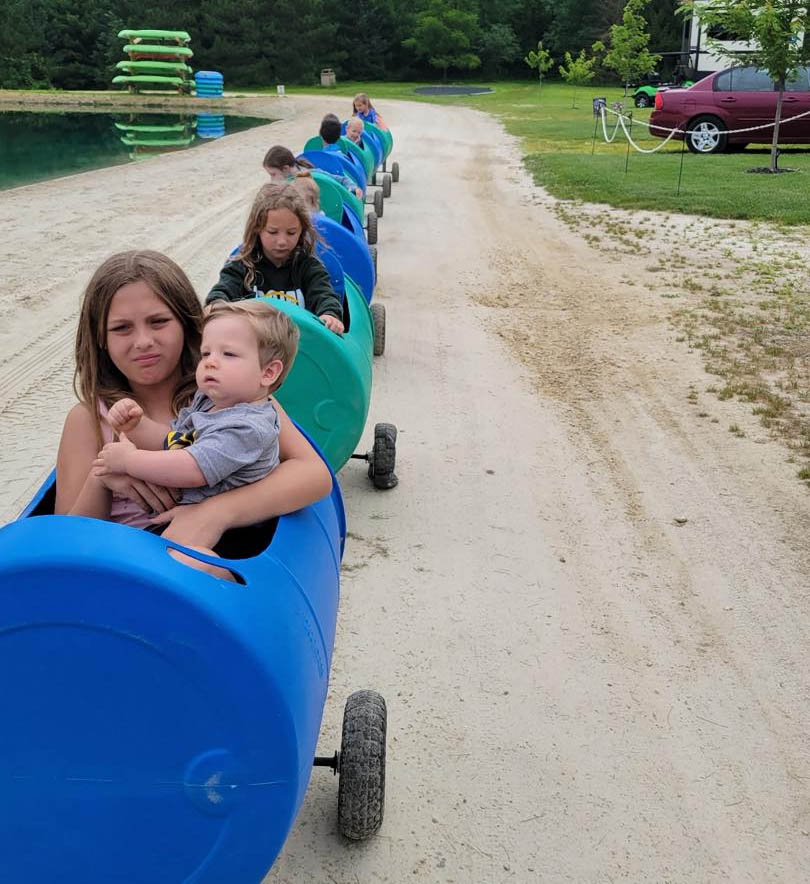 Kids riding the barrel train at a birthday party at Whiskey Creek Family RV Park in Sparta Wisconsin